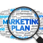 Magnified illustration with the words Marketing Plan on white background.